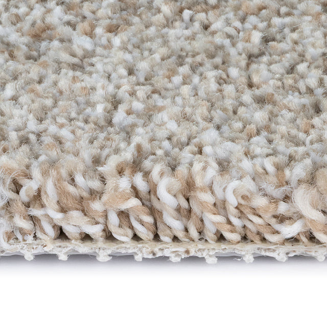 Close-up of a textured beige and white carpet on a white background. Beaulieu Tyresse Ultra Carpet Collection, available with install at Alberta Hardwood Flooring. Visit our showrooms to view this collection, and for product details, and pricing.