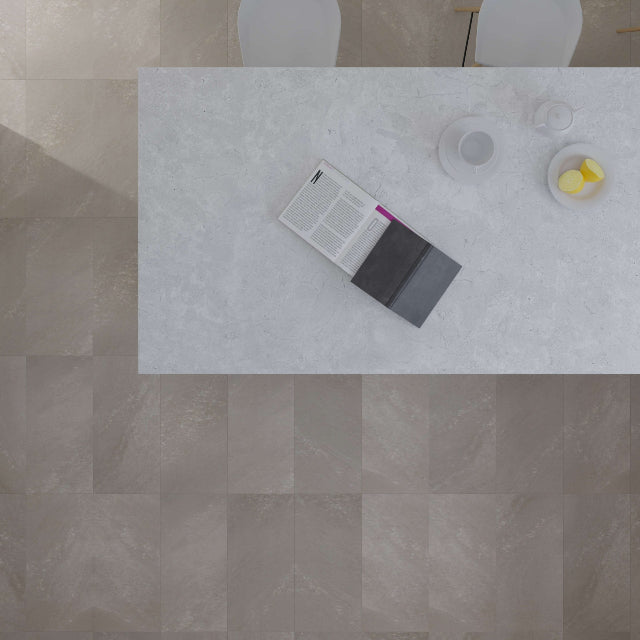 Top-down view of a dining area showing a light gray marble-patterned rectangular table, a dark gray book or folder on top, and a textured beige-taupe tiled floor.

Torlys EverTile™ Premier Cliff Island Luxury Vinyl, a wide plank, low sheen floor available at Alberta Hardwood Flooring.