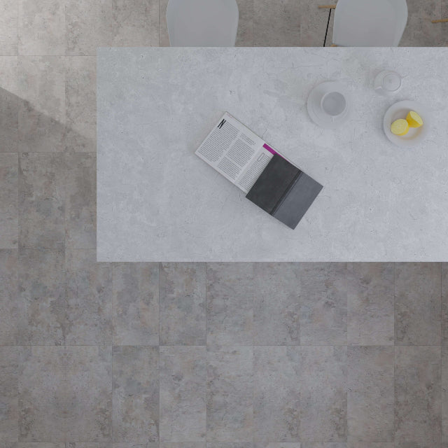 Top-down view of a light gray stone-look rectangular table with a book and small dishes on top, set against a matching gray stone-look floor.

Torlys EverTile™ Premier Bridgewater Luxury Vinyl, a wide plank, low sheen floor available at Alberta Hardwood Flooring.