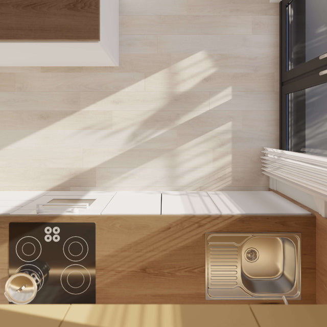 A modern kitchen countertop setup with a black induction cooktop on the left and a single-basin stainless steel sink on the right, integrated into light wood cabinetry against a pale tiled wall with warm sunlight streaming in.

Torlys Rigidwood Firm Premier Eden Luxury Vinyl, a wide plank, low sheen floor available at Alberta Hardwood Flooring.