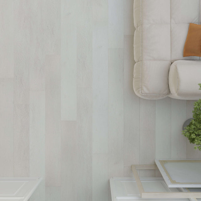 Light beige wood-look flooring shown in a styled interior scene with part of a cream sofa, a small plant, and a white side table visible.

Torlys Rigidwood™ Addington Oak Luxury Vinyl. Wide laminate planks with realistic finishes and unmatched quality, available with install at Alberta Hardwood Flooring.